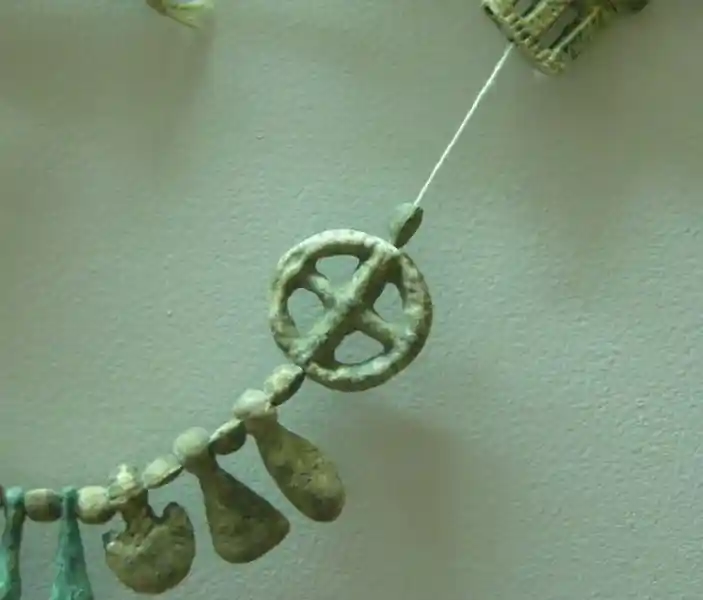 A prechristian cross inside a circle design on a necklace
